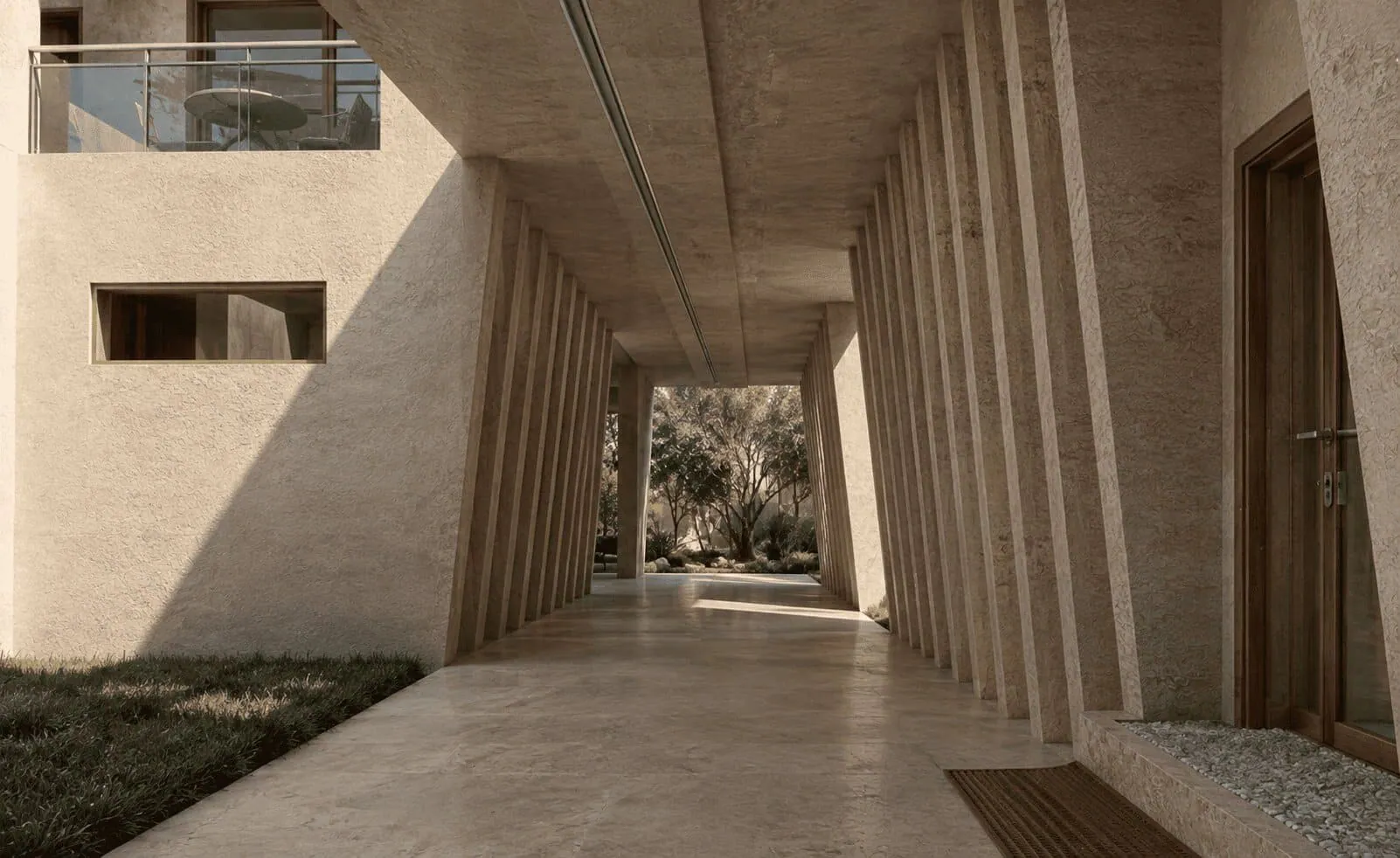 Pasillo en planta baja de la estancia artística: columnata de concreto que divide las habitaciones, con vegetación al fondo.