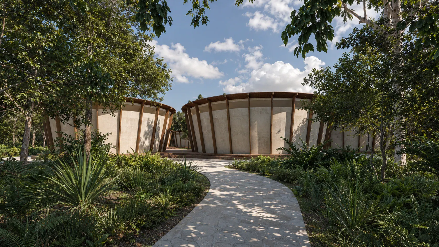 Museo Puuc en el Parque Nuevo Uxmal: volúmenes circulares de tierra y madera entre vegetación tropical.