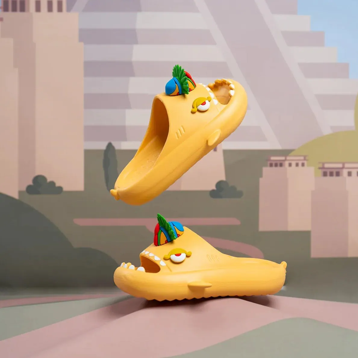 Ilustración promocional de las Sharklas doradas modelo Golden Maya con charms, flotando sobre un paisaje estilizado de pirámide maya.